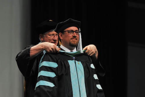 Student being hooded at commencement