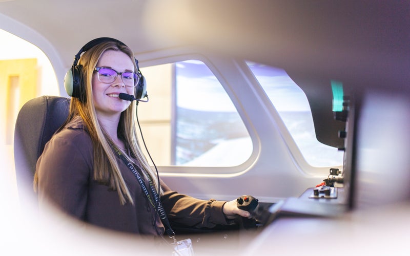 A students in Marshall University's Bill Noe Flight School using a flight simulator to practice flying