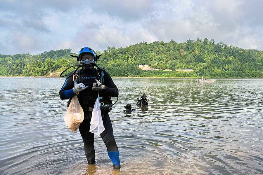 NRES student holding their collection of mussels