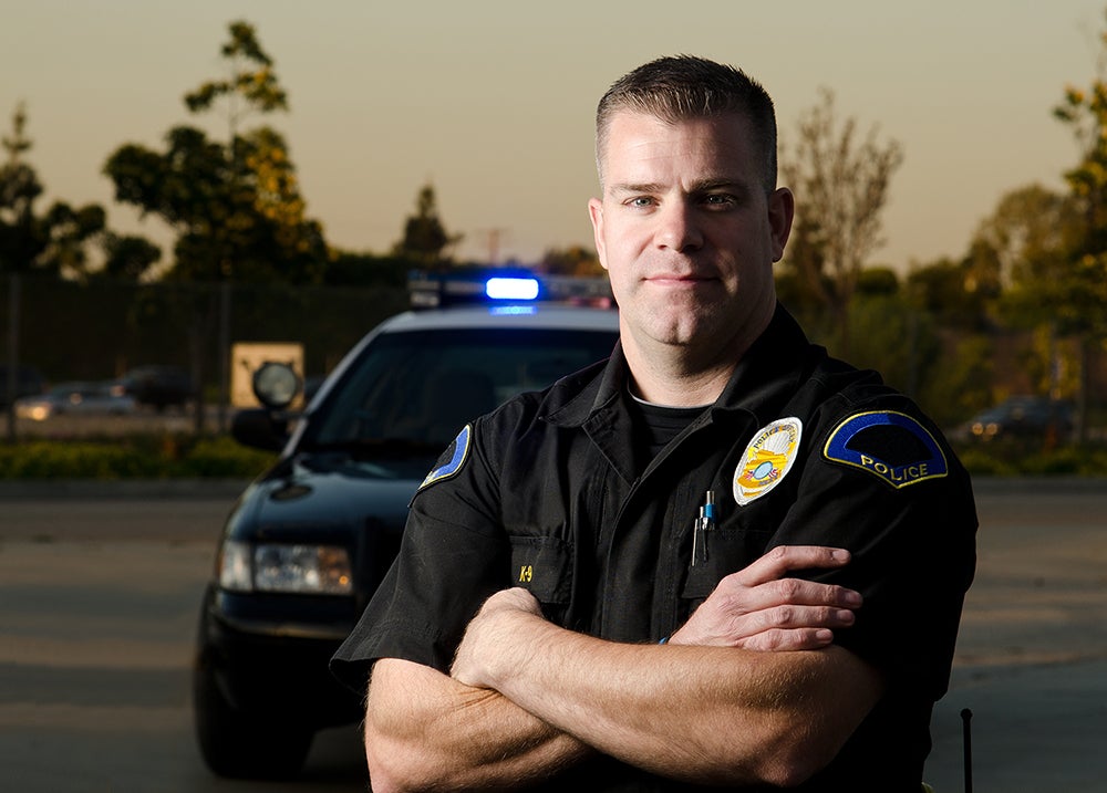 Law enforcement officer in front of car