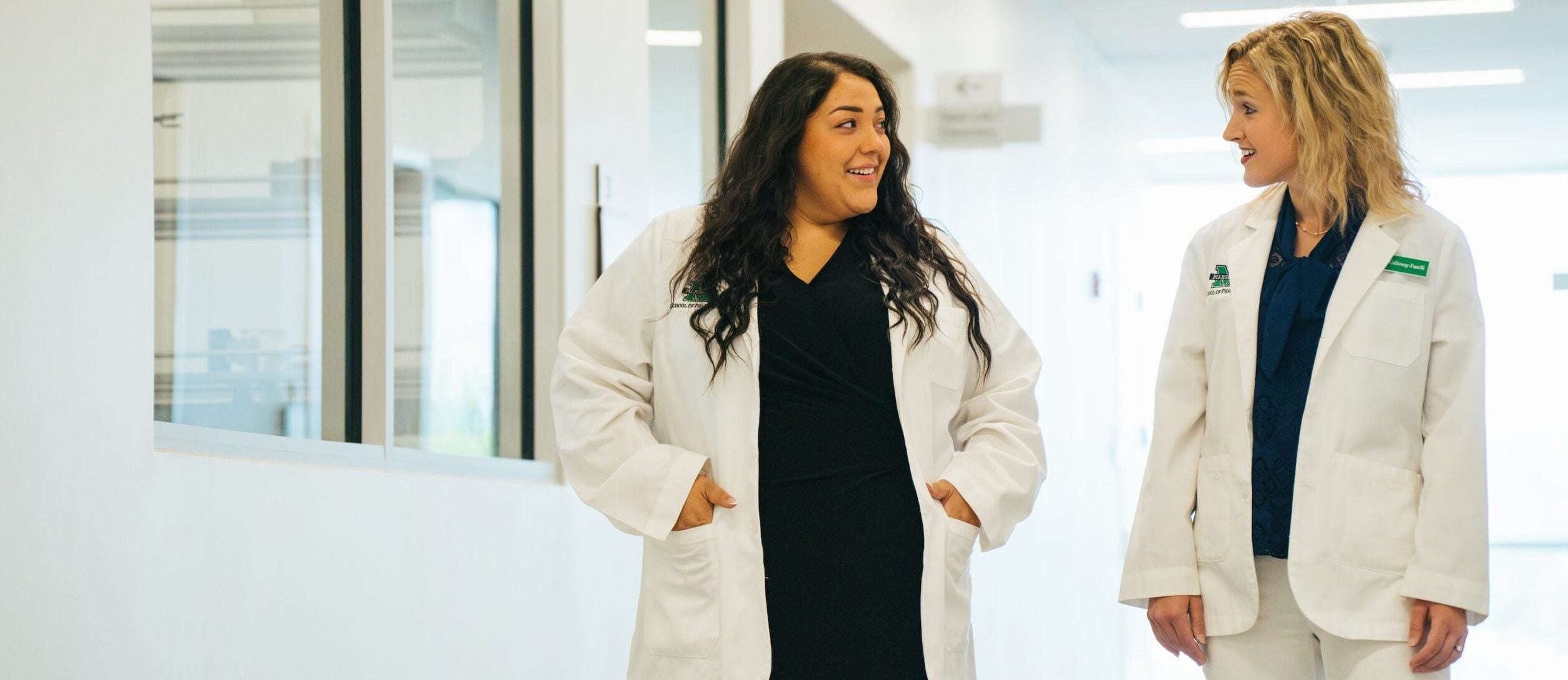 two pharmacy students walking and talking