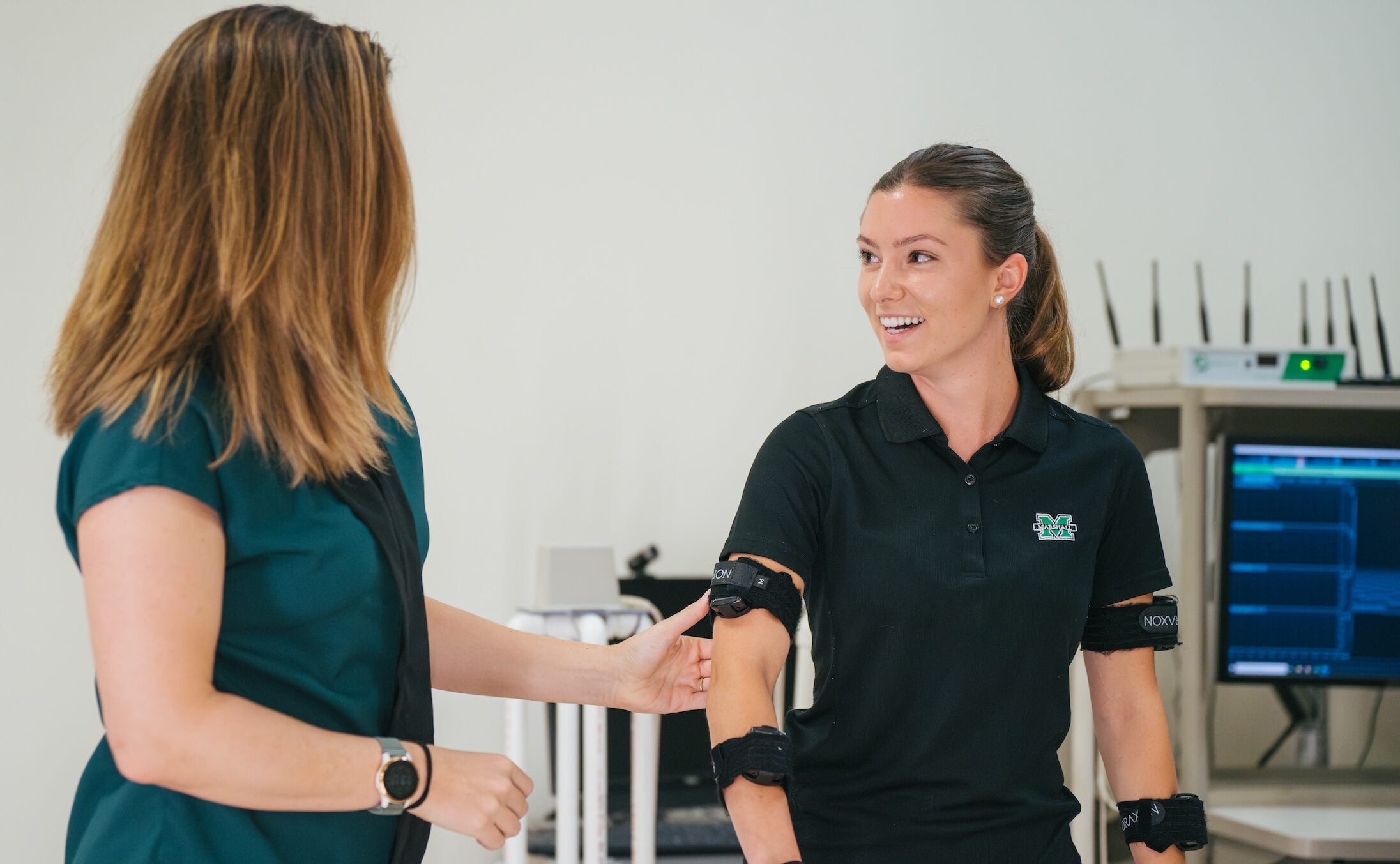 PT student working with a professor on an exercise